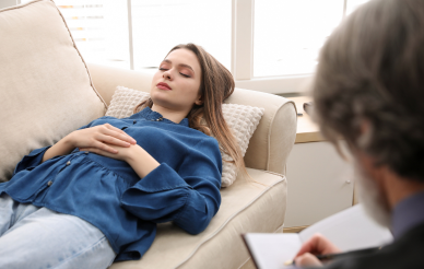 Women laying on the couch at a psychiatry appointment.
